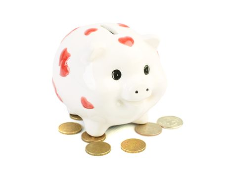 White coin box pig and coins isolated