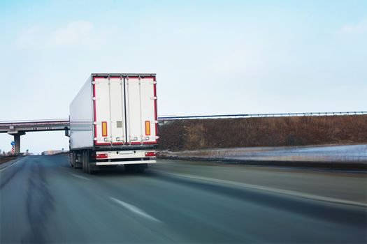 big white truck goes on road