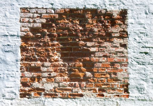 Old brick wall with white plaster