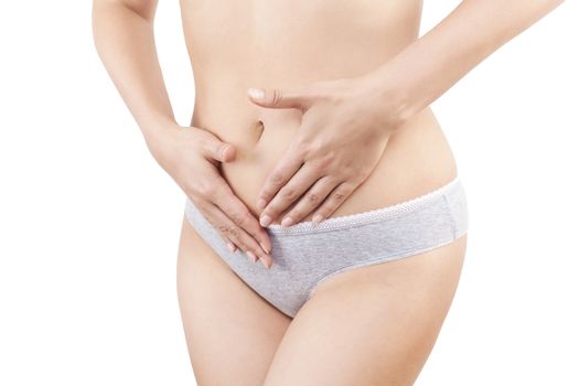 Slim belly. Beautiful woman touching her belly in grey panties isolated on white background. Menstruation, period, pregnancy and weight loss. Feminine body.