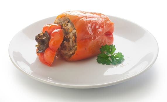 One stuffed red pepper with fresh parsley on the white plate