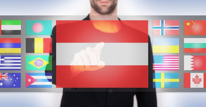 Hand pushing on a touch screen interface, choosing language or country, Austria