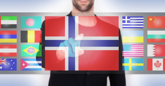 Hand pushing on a touch screen interface, choosing language or country, Norway