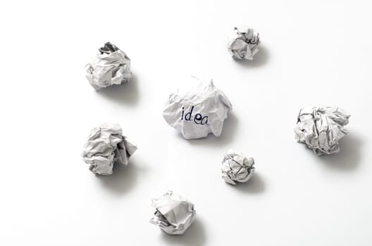 white crumpled paper ball focus idea word on a white background