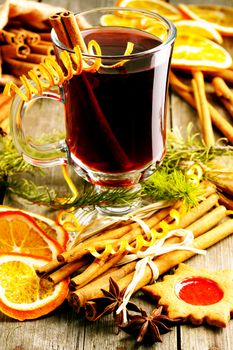 Glass of red mulled wine on wooden table