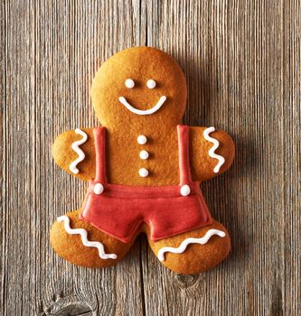 Christmas homemade gingerbread man on wooden table