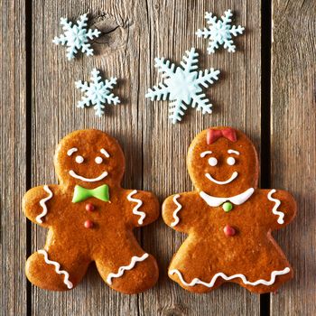 Christmas homemade gingerbread couple cookies on wooden table