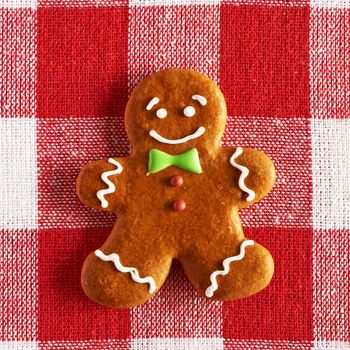 Christmas homemade gingerbread man on tablecloth