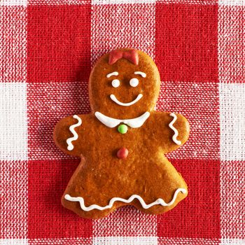 Christmas homemade gingerbread girl on tablecloth