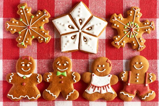Christmas homemade gingerbread couples on tablecloth