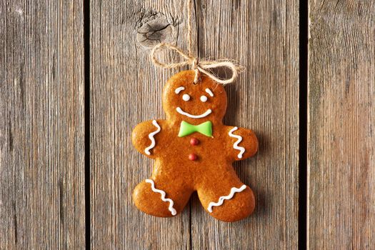 Christmas homemade gingerbread man over wooden background