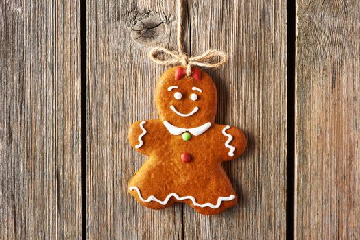 Christmas homemade gingerbread girl over wooden background