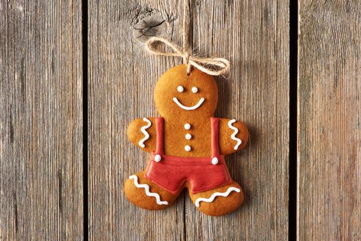 Christmas homemade gingerbread man over wooden background