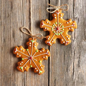 Christmas homemade gingerbread cookies over wooden background