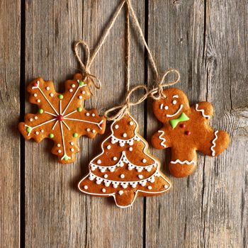 Christmas homemade gingerbread cookies over wooden background