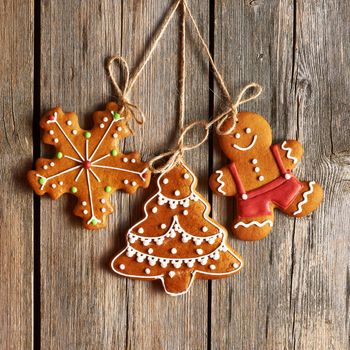 Christmas homemade gingerbread cookies over wooden background