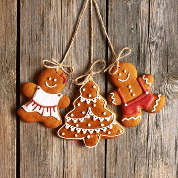 Christmas homemade gingerbread couple cookies over wooden background