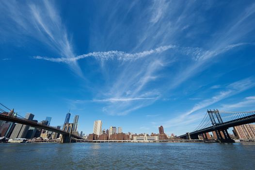 Manhattan skyline view from Brooklyn between Brooklyn Bridge and Manhattan Bridge in New York City