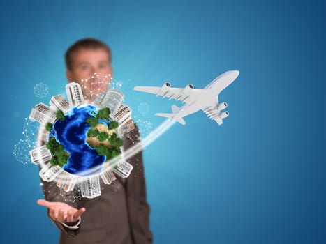 Businessman holding earth with buildings. Element of this image furnished by NASA