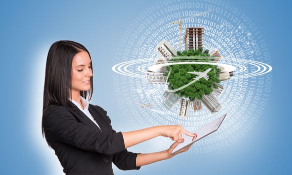 Beautiful businesswomen in suit using digital tablet. Green Earth with buildings, construction site and airplanes