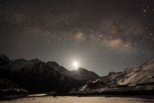 Night sky and stars passing by behind mountain Taboche, Cholatse, Machhermo village. Nepal