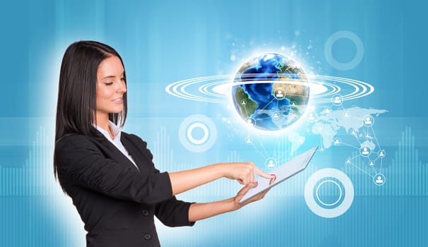 Beautiful businesswomen in suit using digital tablet. Earth with world map, graphs and network. Element of this image furnished by NASA