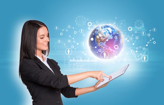 Beautiful businesswomen in suit using digital tablet. Earth with graphs and network. Element of this image furnished by NASA