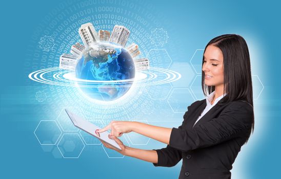 Beautiful businesswomen in suit using digital tablet. Earth with buildings, hexagons and figures. Element of this image furnished by NASA
