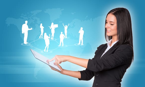 Beautiful businesswomen in suit using digital tablet. Silhouettes of business people and world map