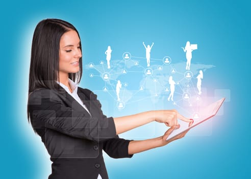 Beautiful businesswomen in suit using digital tablet. Silhouettes of business people and network