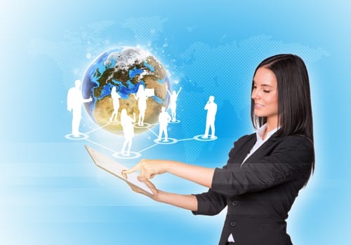 Beautiful businesswomen in suit using digital tablet. Earth with silhouettes of business people. Element of this image furnished by NASA