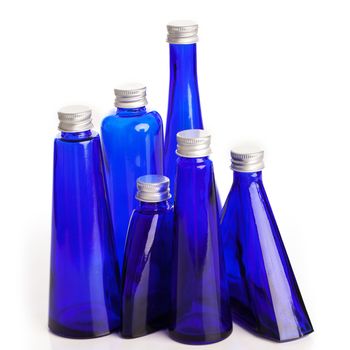 Little blue bottles isolated over white background