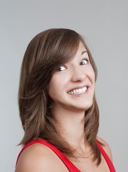 portrait of a beautiful young brunette with brown eyes - isolated on gray