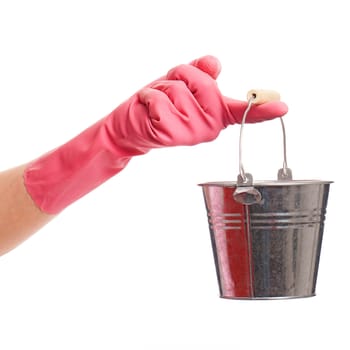 Hand in a pink domestic glove holding silver pail isolated over white background