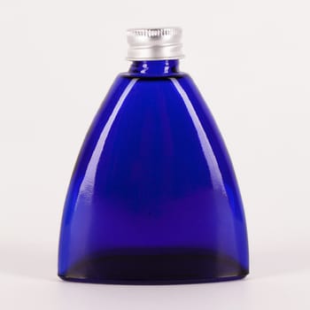 Little blue bottle isolated over white background