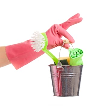 Hand in a pink domestic glove holding silver pail isolated over white background