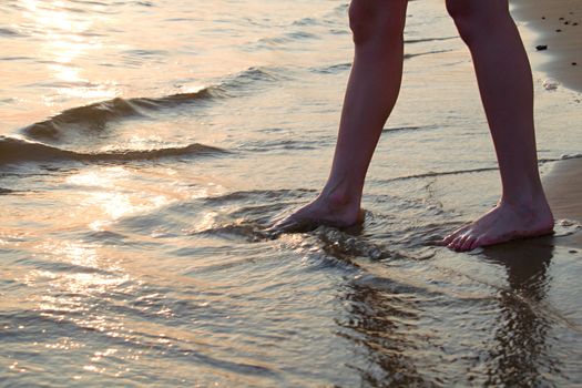 Photo shows a sunset above the beach and sea.