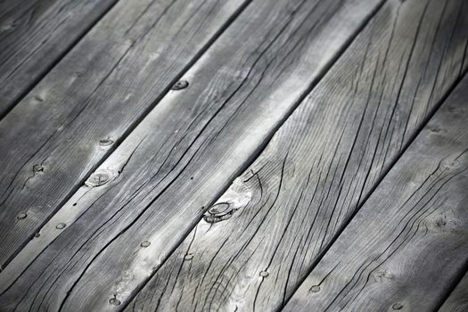 Old weathered grey wood plank background at an angle