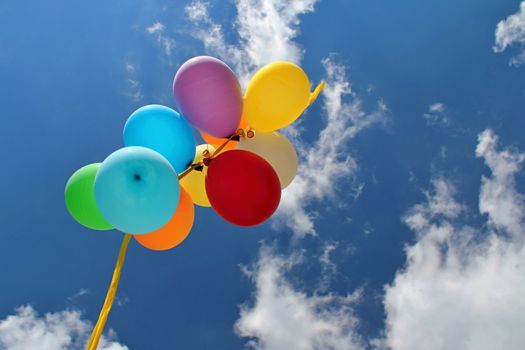 Photo shows colourful balloons in the sky.