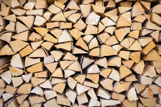 Chopped and stacked pile of pine and birch wood background
