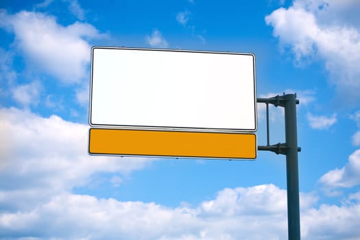 Road billboard against blue sky