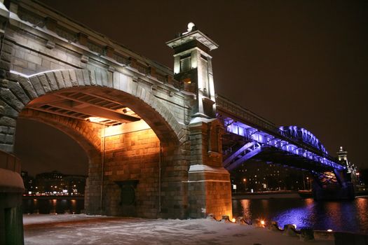  stone bridge at night colour fires in Moscow in the winter.