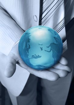 Globe glass blue in hands at the businessman