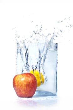  apple and lemon in water and splashes is isolated