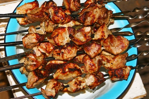 Shish kebab from pork on skewers outside