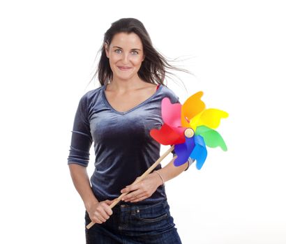 beautiful young woman holding a multicolored pinwheel - isolated on white