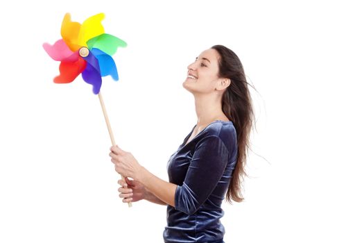 beautiful young woman holding a multicolored pinwheel - isolated on white