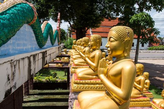 the group of golden buddhas at Thai temple in Thailand