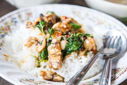 delicious traditional spicy Thai holy basil stir fry on rice