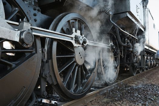 Steam locomotive rolling by close